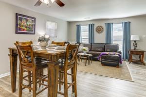 a living room with a table and a couch at Tiger Town Retreat: Spacious 3-Home Retreat! in Baton Rouge
