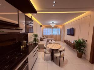 a kitchen and living room with a table and a couch at Votre escapade d été à deux pas de la plage in Kenitra