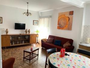 a living room with a couch and a table at Casa Ti Carolina in Nazaré