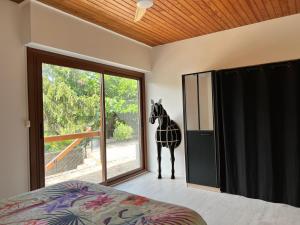 a statue of a giraffe standing in a bedroom at L'Olivada, villa d'exception in Ganges +34 photos
