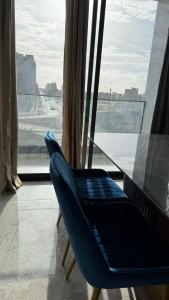 a blue chair sitting in front of a window at Kevin Island House in Ilhéu de Santa Maria
