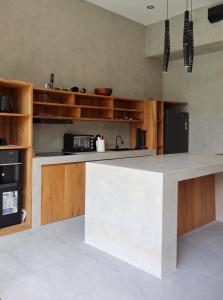 a kitchen with a large white island in the middle at Villa Donald in Canggu