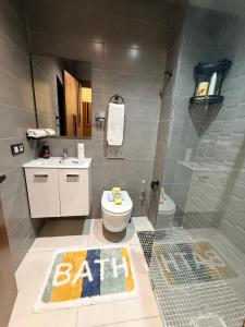 a bathroom with a toilet and a bath sign on the floor at Votre escapade d été à deux pas de la plage in Kenitra +21 photos