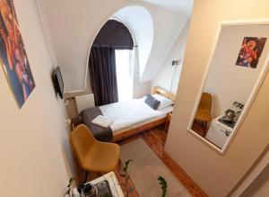 a small room with a bed and a mirror at Mátyás Szállás Panzió in Szombathely +22 photos