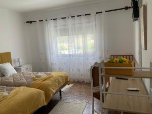a bedroom with a bed and a window at Casa Ti Carolina in Nazaré