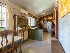 a kitchen with a wooden table and a refrigerator at casa montepio in San Antonio de Areco +17 photos