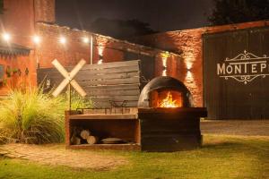 a brick building with a fire oven in the yard at casa montepio in San Antonio de Areco