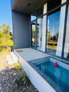 a swimming pool in front of a house at Loft industrial Colchagua in Santa Cruz