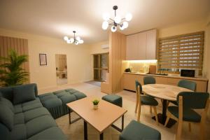 a living room with a couch and a table at Dedi Apartment 1 in Shkodër