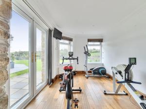a gym with bikes and exercise equipment in a room at Chapel Green Studio in St Austell
