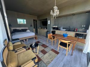 a living room with a bed and a table and chairs at Loft industrial Colchagua in Santa Cruz