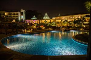 a swimming pool in front of a building at night at Dreams Playa Bonita All Inclusive in Playa Bonita Village