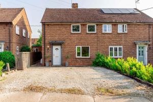 a brick house with a driveway in front of it at Comfortable 3BED House with Garden & Parking in Colchester