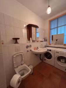 a bathroom with a toilet and a sink at Surya Villa Holistic Stay Prenzlauer Berg in Berlin +21 photos
