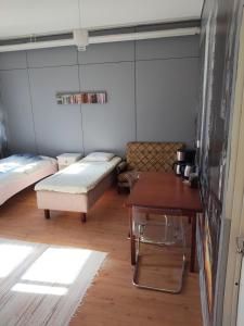 a room with two beds and a table at Willa Witsari 27m2 in Kokkola