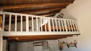 a white staircase in a room with wooden ceilings at Quinta Martins in Loulé