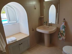 a bathroom with a sink and a mirror at Quinta Martins in Loulé +14 photos