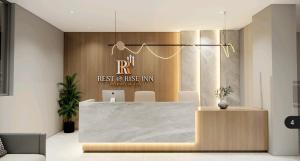 a restaurant with a reception desk in a lobby at Rest and Rise Inn in Bhīmavaram