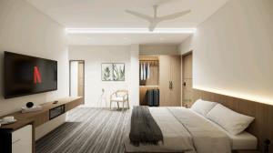 a bedroom with a large bed and a flat screen tv at Rest and Rise Inn in Bhīmavaram +18 photos