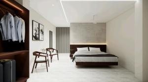 a bedroom with a bed and a table and chairs at Rest and Rise Inn in Bhīmavaram