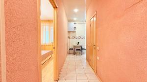 a hallway leading to a dining room with a table at Naykova district Apartments in Kharkiv +232 photos