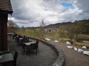a row of tables and chairs on a patio at The Gather - Tarbert Argyll in Tarbert