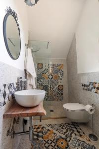 a bathroom with a sink and a toilet and a mirror at Villa con piscina Seychelles del Salento in Marina di Pescoluse +44 photos