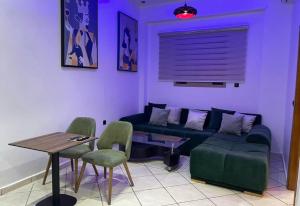 a living room with a couch and a table and chairs at saviohome in Ouarzazate