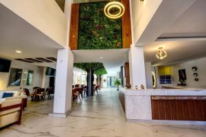 a lobby with a large plant on the wall at Hotel Boutique La Torre in Tupiza +26 photos