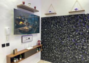 a living room with a wall with a large tv at saviohome in Ouarzazate +1 photo