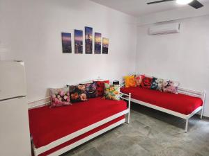 two beds in a room with red sheets at Blue Port Faros - Sifnos in Faros
