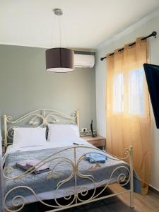 a bedroom with a bed with a metal frame at Casa Nikolou Stegna in Archangelos