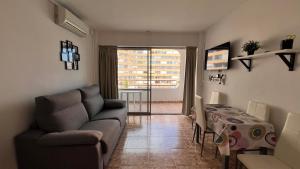 a living room with a couch and a table at Estudio con piscina in Roses