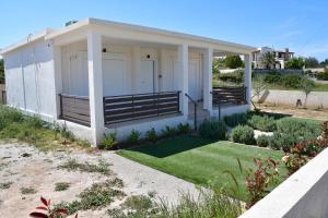 a small white house with a small yard at Maria's Dreamhouse in Egina