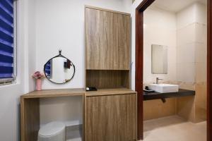 a bathroom with a sink and a mirror at Hotel Trung Mai-Sân Bay in Ho Chi Minh City