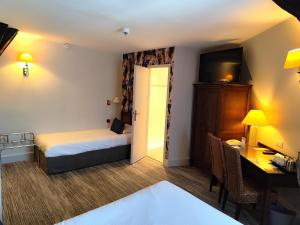 a hotel room with a bed and a desk and a computer at Best Western de Diane in Nevers