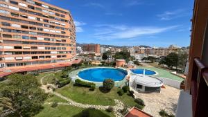 arial view of a swimming pool in front of a building at Estudio con piscina in Roses
