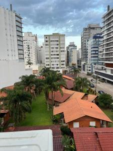 a view of a city with palm trees and buildings at Apartamento Completo Duas Quadras do Mar in Capão da Canoa