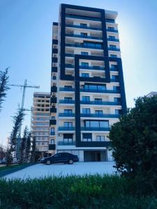 a car parked in front of a tall building at Premium Lakeside Apartament Building Stefan in Mamaia +14 photos