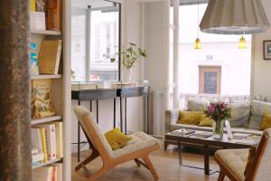 a living room with a table and a couch at Hotel Litteraire Marcel Ayme, BW Premier Collection in Paris