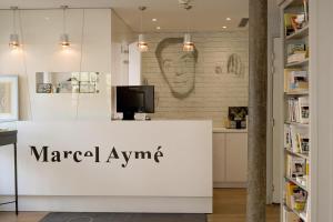 a sign for a market awp in a store at Hotel Litteraire Marcel Ayme, BW Premier Collection in Paris
