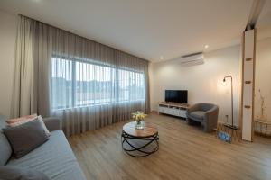 a living room with a couch and a tv at Chez Nous I e II in Caloura