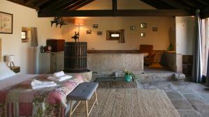 a bedroom with a bed and a tub in a room at Quinta da Bela Vista do Lima in Ponte de Lima