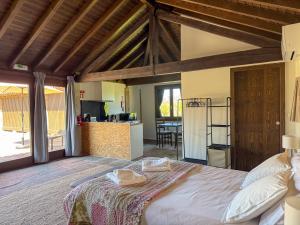 a bedroom with a large bed and a kitchen at Quinta da Bela Vista do Lima in Ponte de Lima +80 photos