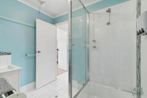a bathroom with a shower with a glass door at Ocean Spray in Lancelin +14 photos