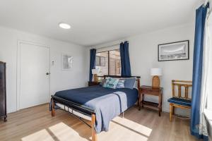 a bedroom with a bed and a window at Ocean Spray in Lancelin