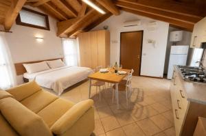 a living room with a couch and a table at Residence Mediterraneo - Agenzia Cocal in Caorle
