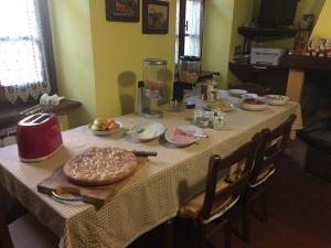 a table with a table cloth with food on it at B&B QUIConti in Agnino
