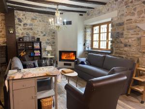 a living room with a couch and a fireplace at Casa Rural Donamariako Benta in Donamaría