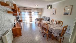 a kitchen and dining room with a table and chairs at Casa García in L'Aldea